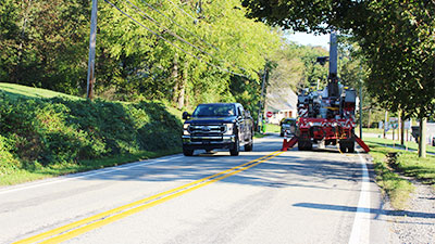 A truck passes a utility vehicle